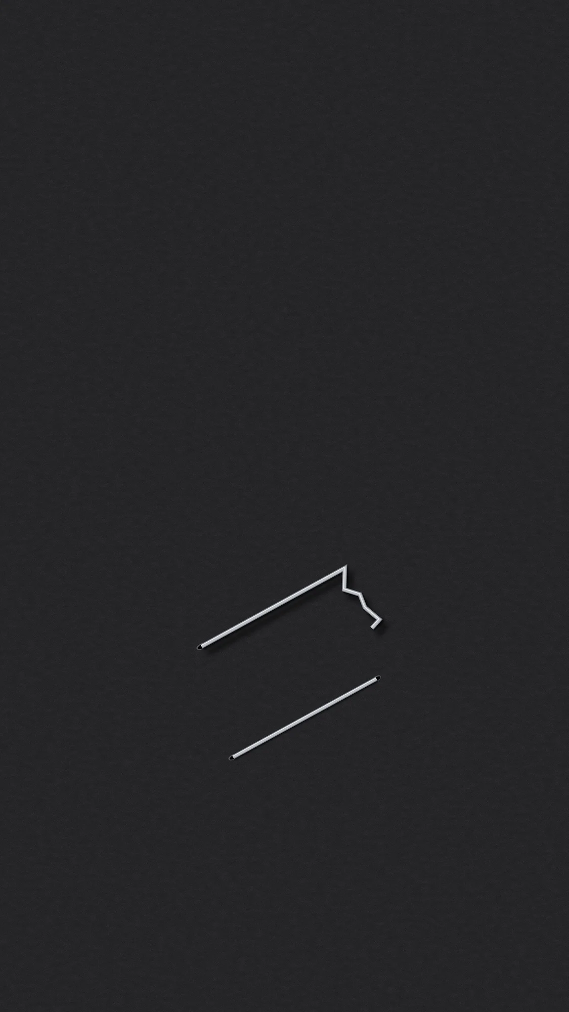 Misfire: One misfired staple with a crumpled leg sits on black card stock, and a neat, flat second staple lies just below it.